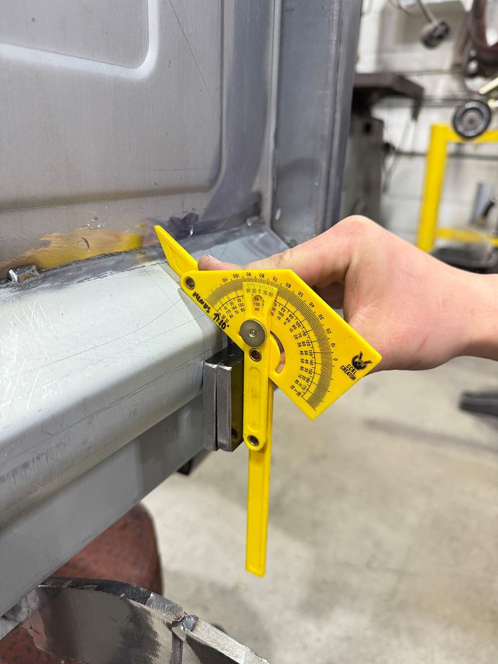 15 Yellow Empire angle finder on tailgate corner degree scale visible welded joint