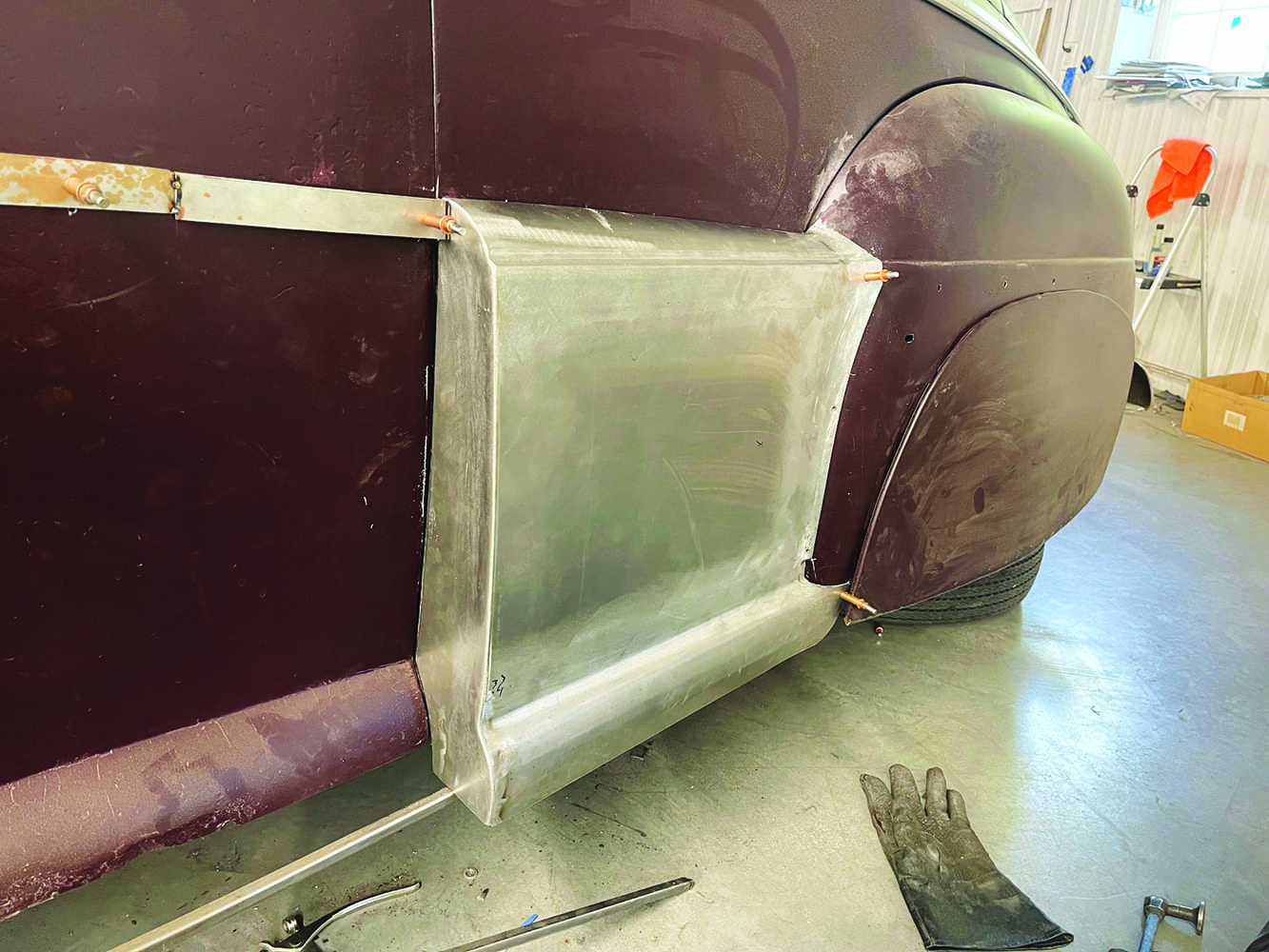 18 1947 Ford coupe rear fadeaway fender after shaping cleco fasteners workshop background