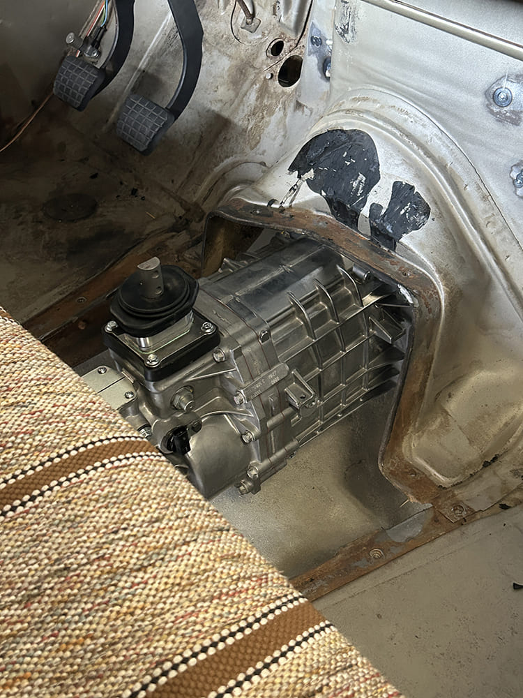 19 Interior Chevy C10 transmission tunnel with manual gearbox exposed shifter seat upholstery visible