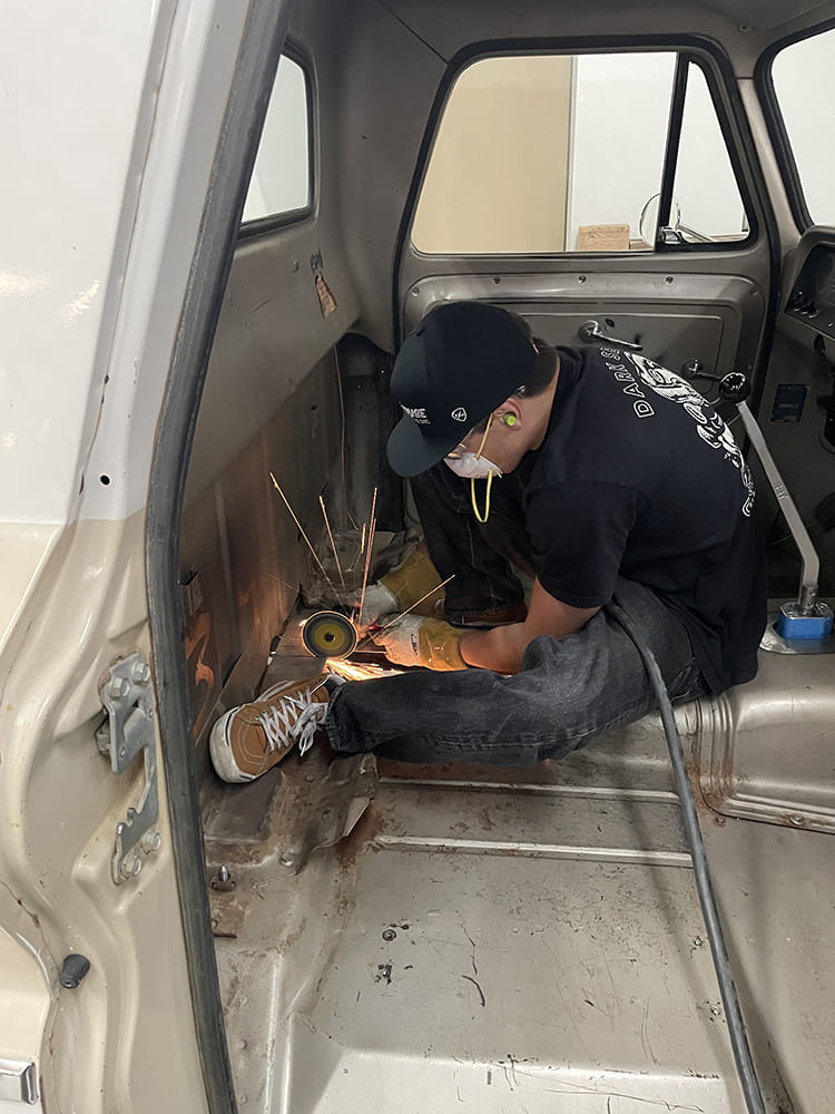 21 grinding transmission tunnel interior angle grinder sparks 1960s Chevrolet C10 cab