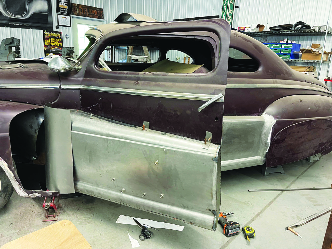25 1947 Ford coupe door open fadeaway fender panels attached tape measure drill and scissors visible