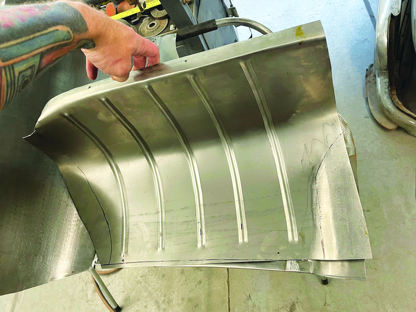 26 Custom ribbed metal panel for 1947 Ford coupe fadeaway fender hand holding panel tattoo visible