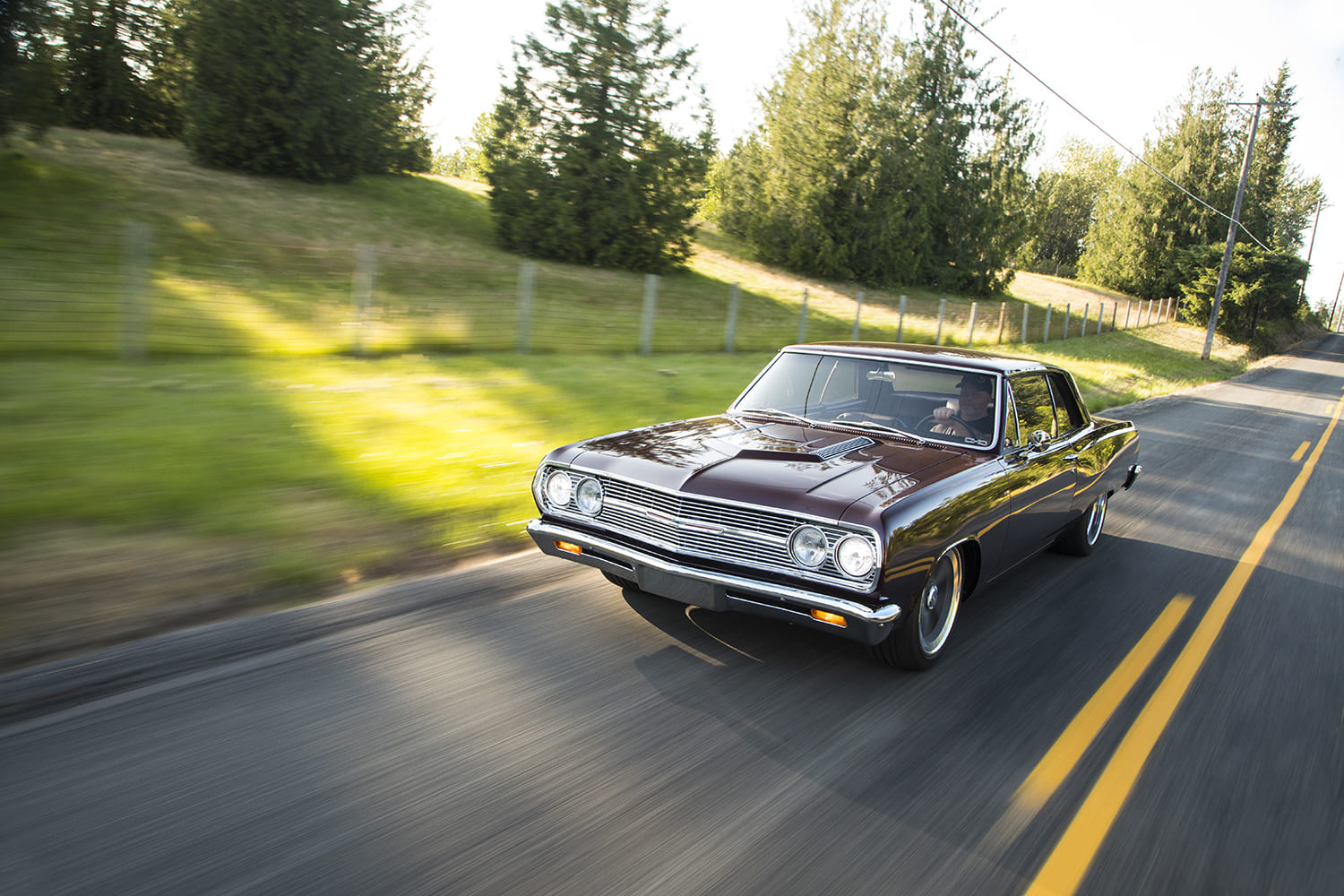 002 1965 Chevrolet Chevelle cruising highway motion shot classic muscle car