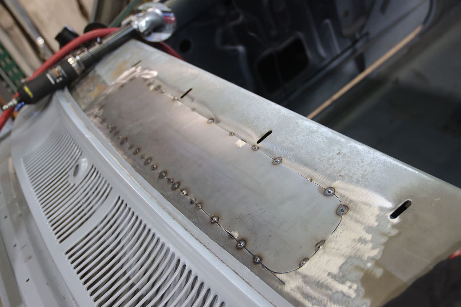 004 1967 Nova cowl patch panel tack welded metal shaping in progress custom vent delete panel