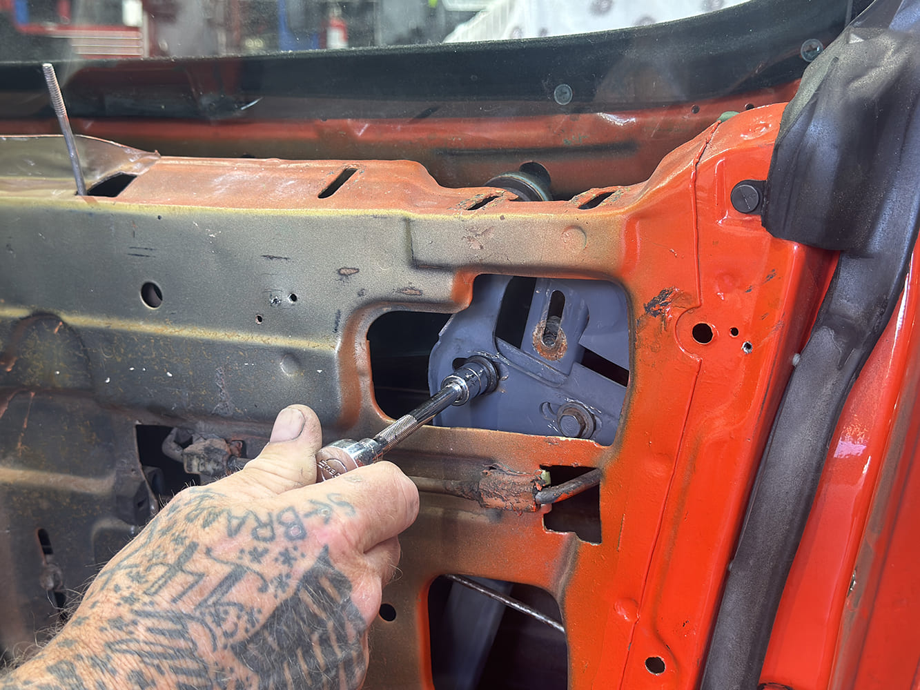 009 1971 camaro window regulator bolt install closeup with ratchet tool