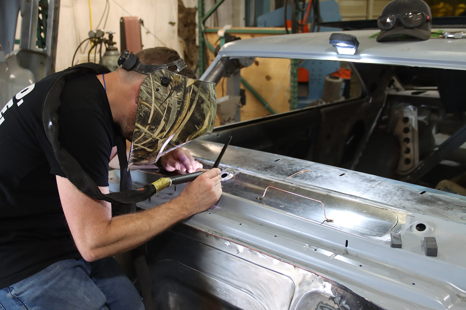 021 1967 Nova cowl patch tacked in place with TIG torch and scribe used for tight seam alignment