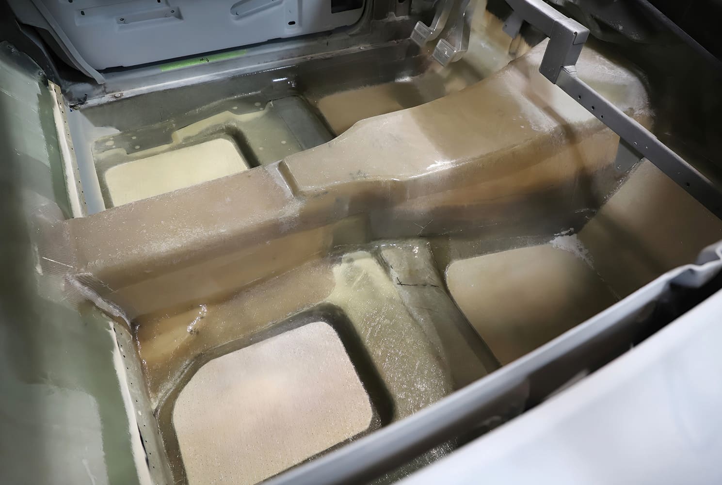 023 1965 Corvette fiberglass floor pan formed with blended reinforcement zones