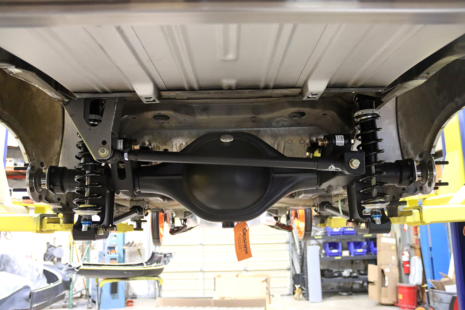 020 1963 Chevy Nova Technician tightens upper control arm on installed QUADRALink rear suspension