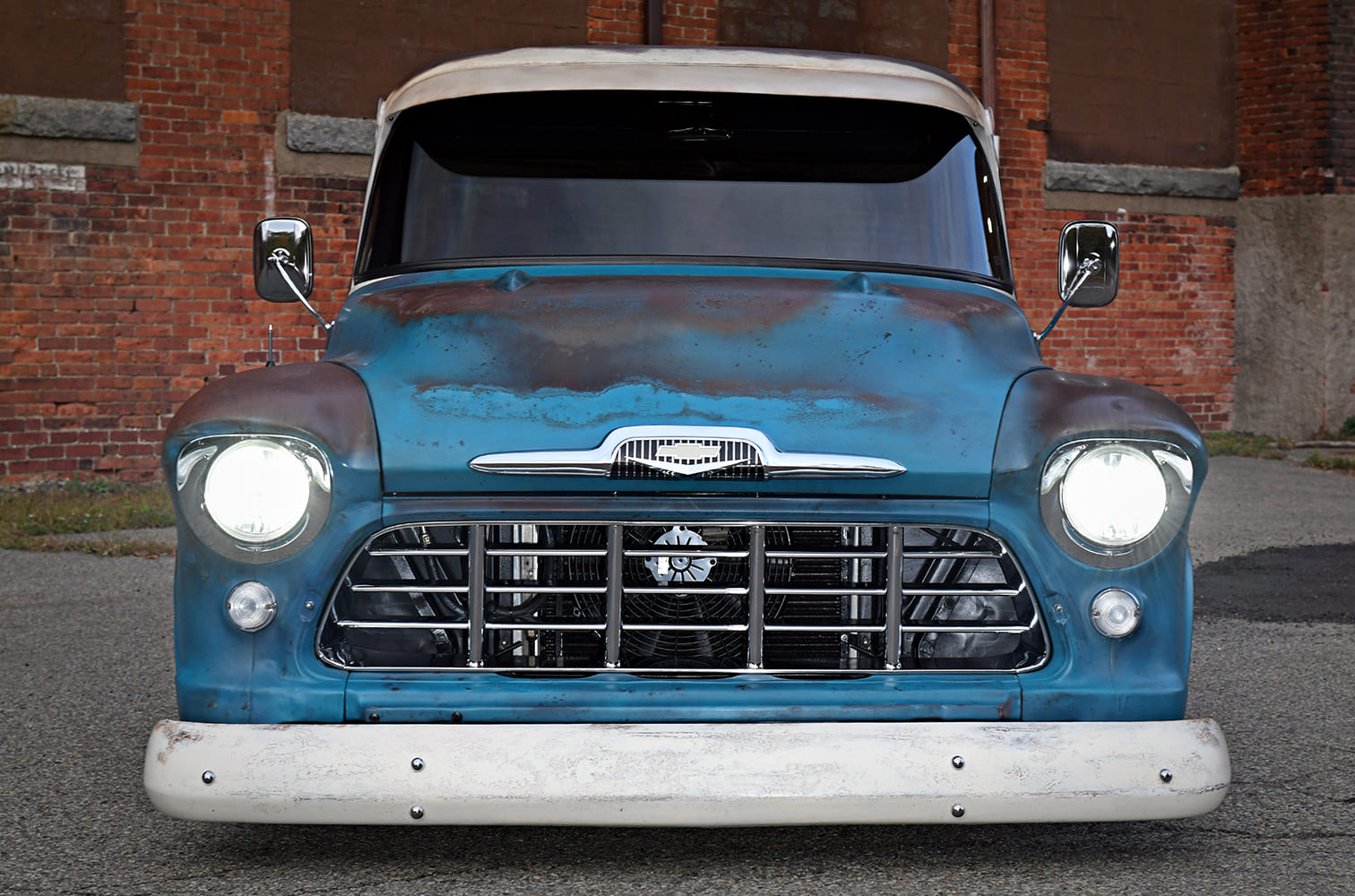 06 1957 Chevy 3100 front view patina headlights on chrome grille