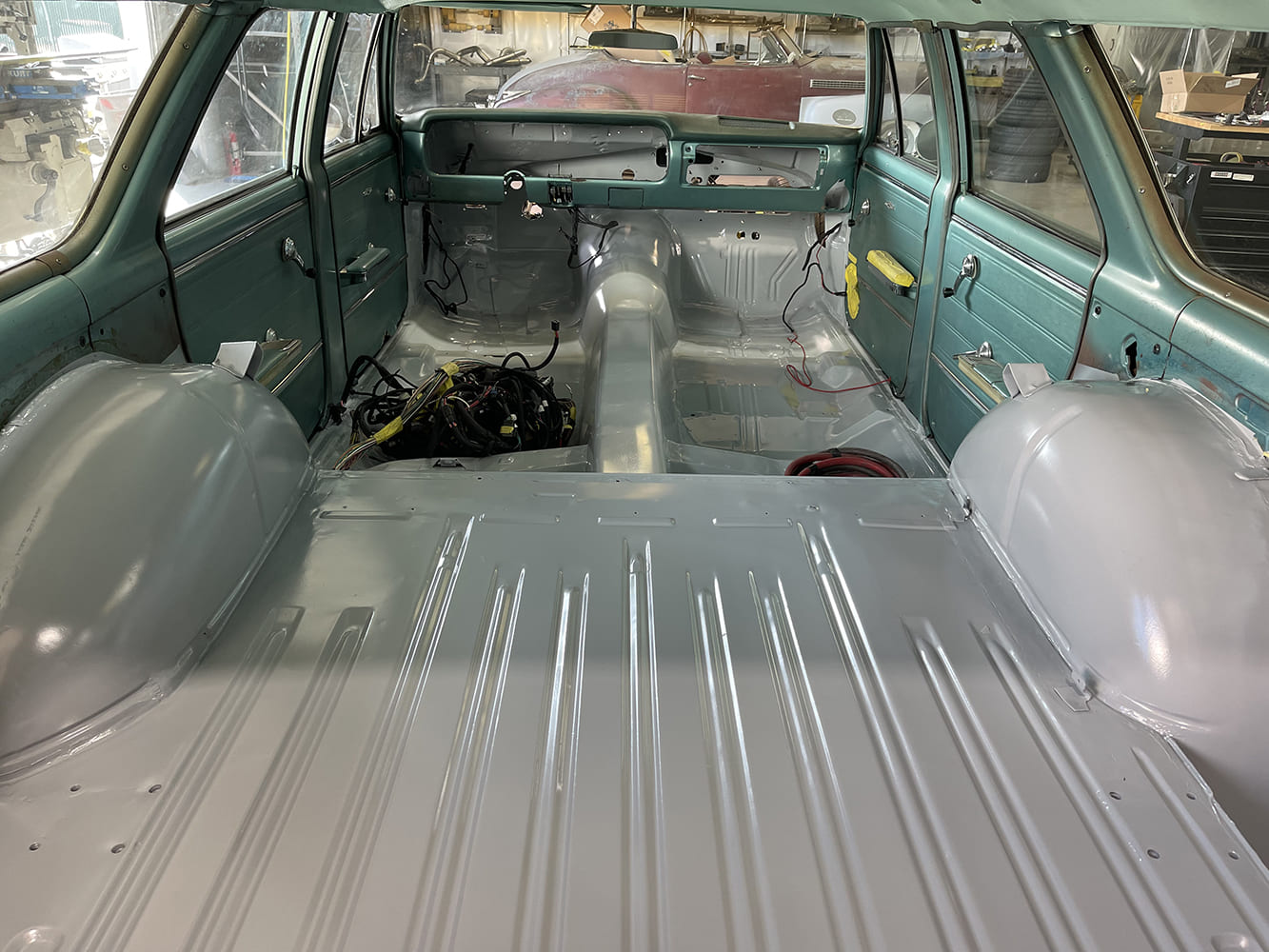 11 1965 chevelle wagon interior bare metal floor painted with wiring harness laid out for install