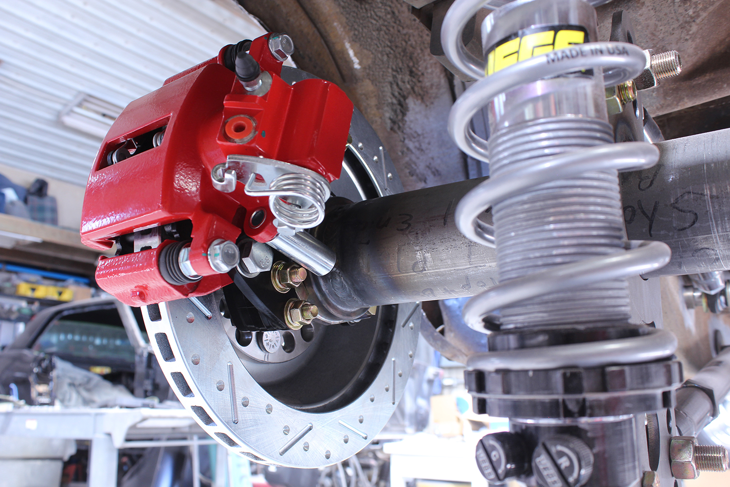 14 1965 mustang cpp red caliper install close up slotted disc jegs coilover suspension rear axle