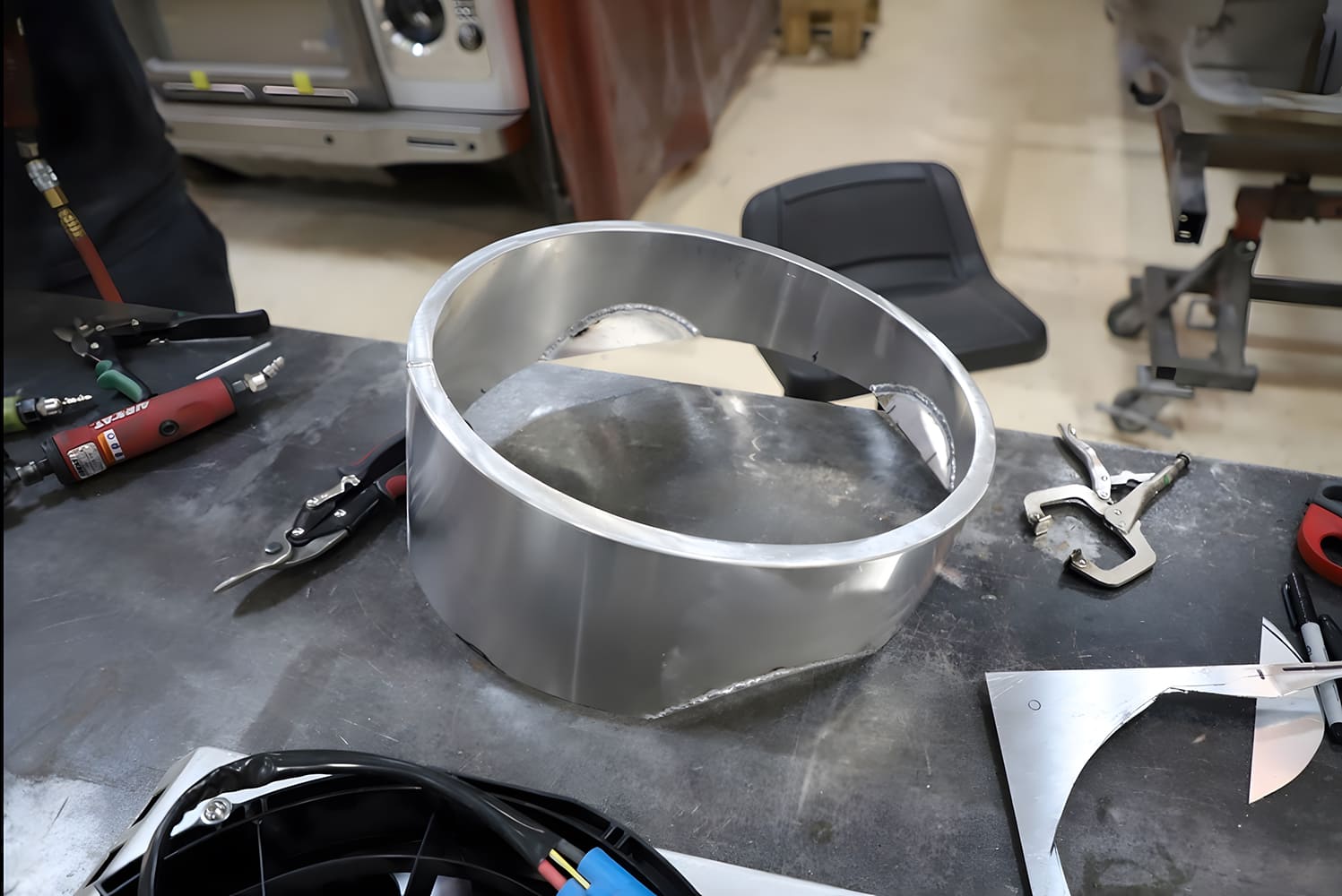 1965 Chevy Corvette Partially trimmed fan shroud with cutout contour taking shape on workbench