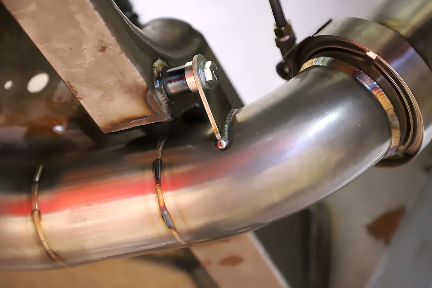 Corvette custom exhaust hanger bracket tig welded to stainless pipe and frame mount tab