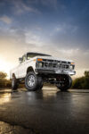 02 1977 Ford F 150 lifted classic truck wet pavement golden hour