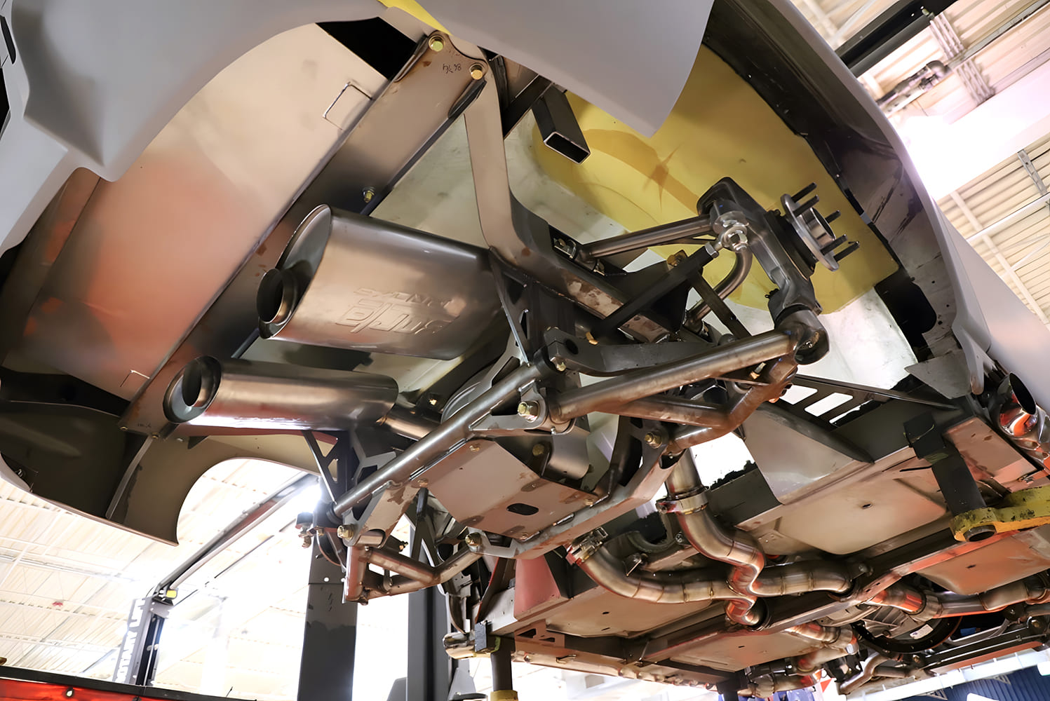 Borla exhaust tucked under custom paneling with IRS and mandrel bent stainless tubing