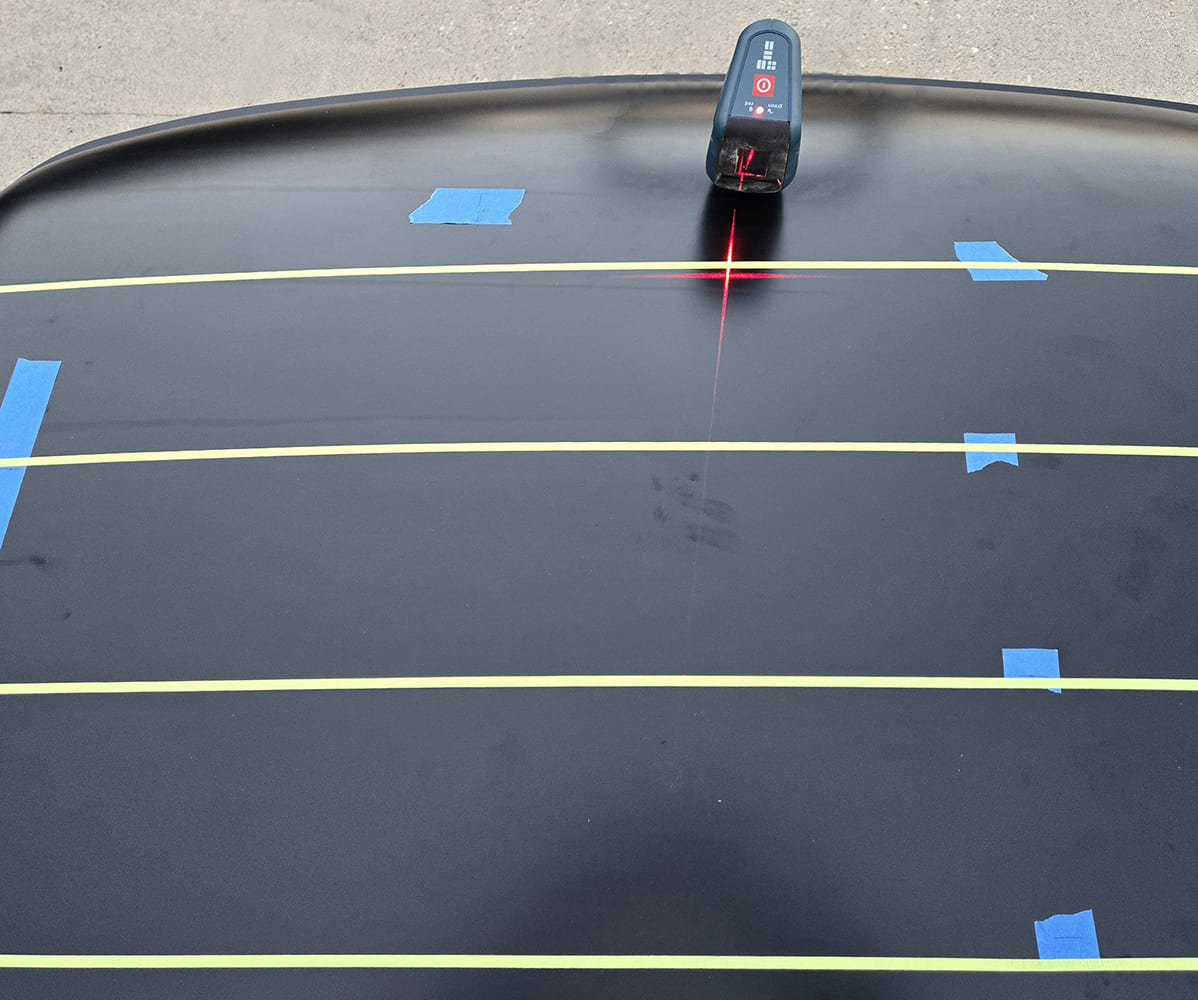 Laser being used to layout roof lines