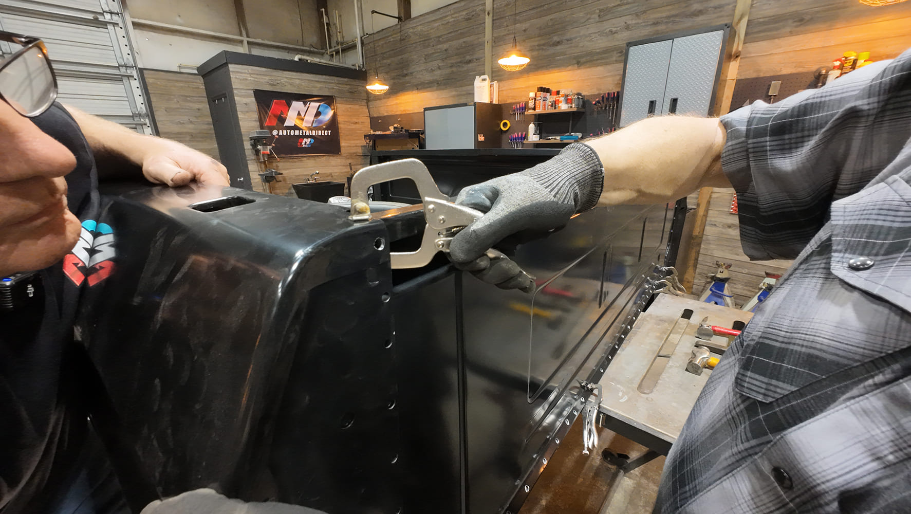 attaching bedside panels to the front panel with C clamps before welding