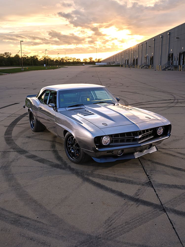 1969 Chevrolet Camaro custom pro touring silver front three quarter sunset parking lot performance build