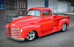 47 Chevrolet 3100 custom red pickup truck front three quarter view chrome grille lowered street rod