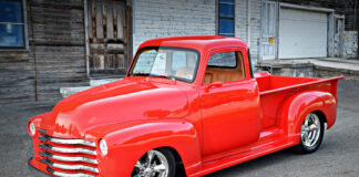47 Chevrolet 3100 custom red pickup truck front three quarter view chrome grille lowered street rod
