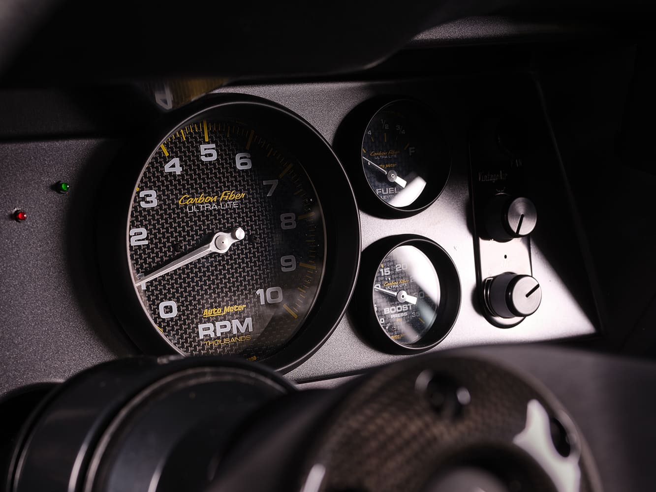 1969 Chevrolet Camaro custom carbon fiber gauge cluster AutoMeter tach boost gauges interior detail