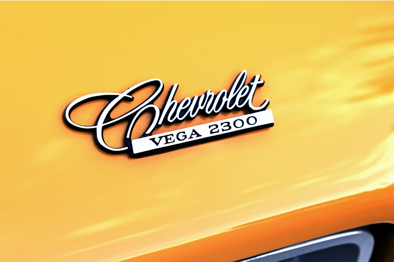 017 1971 Chevrolet Vega 2300 emblem badge close up yellow body panel script detail
