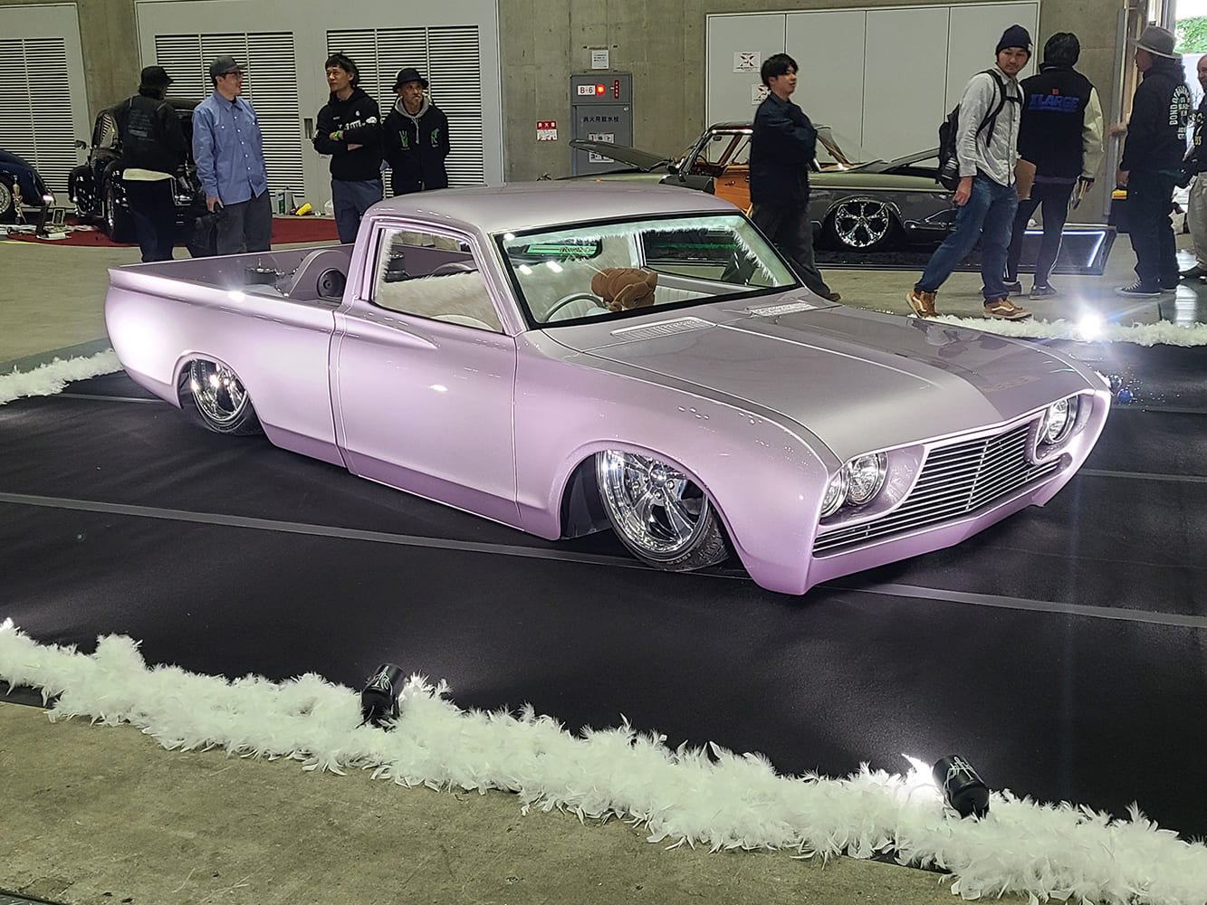 Custom pastel pink lowered mini truck air suspension indoor car show