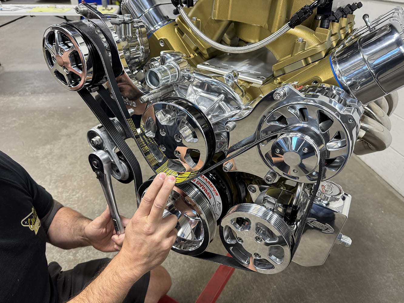 ls accessory drive system with pulleys onto a gold colored engine block featuring a gates racing belt