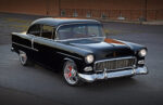 This Dusky Big-Block 1955 Chevy Makes the Ultimate Hot Rod 1955 Chevrolet Bel Air black custom restomod front three quarter view lowered stance polished wheels