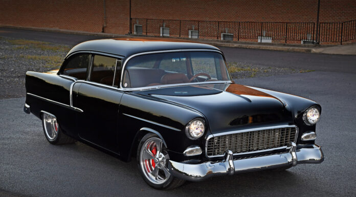 This Dusky Big-Block 1955 Chevy Makes the Ultimate Hot Rod 1955 Chevrolet Bel Air black custom restomod front three quarter view lowered stance polished wheels