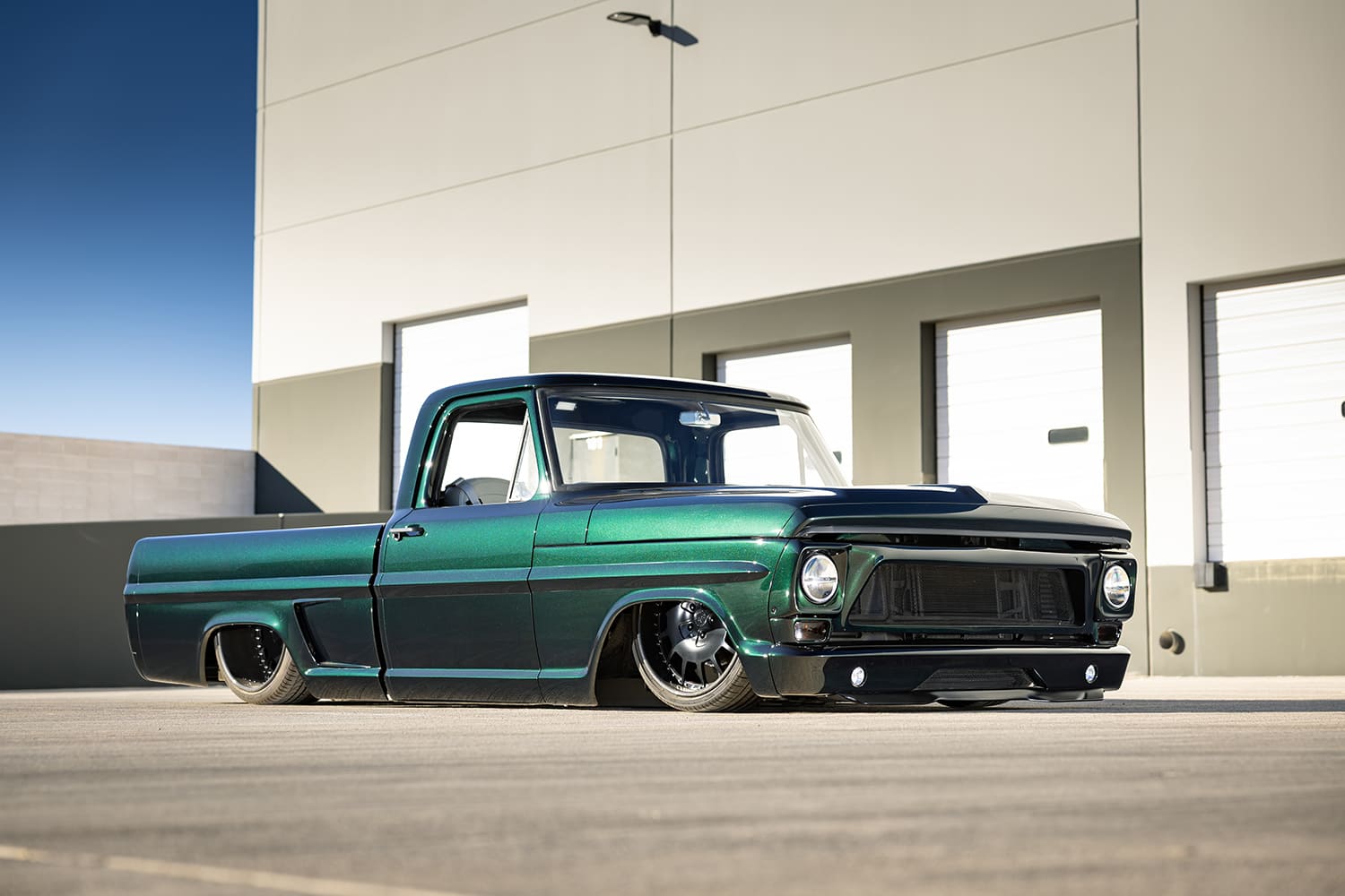 67 Ford F100 custom lowered front three quarter view black mesh grille LED fog lights