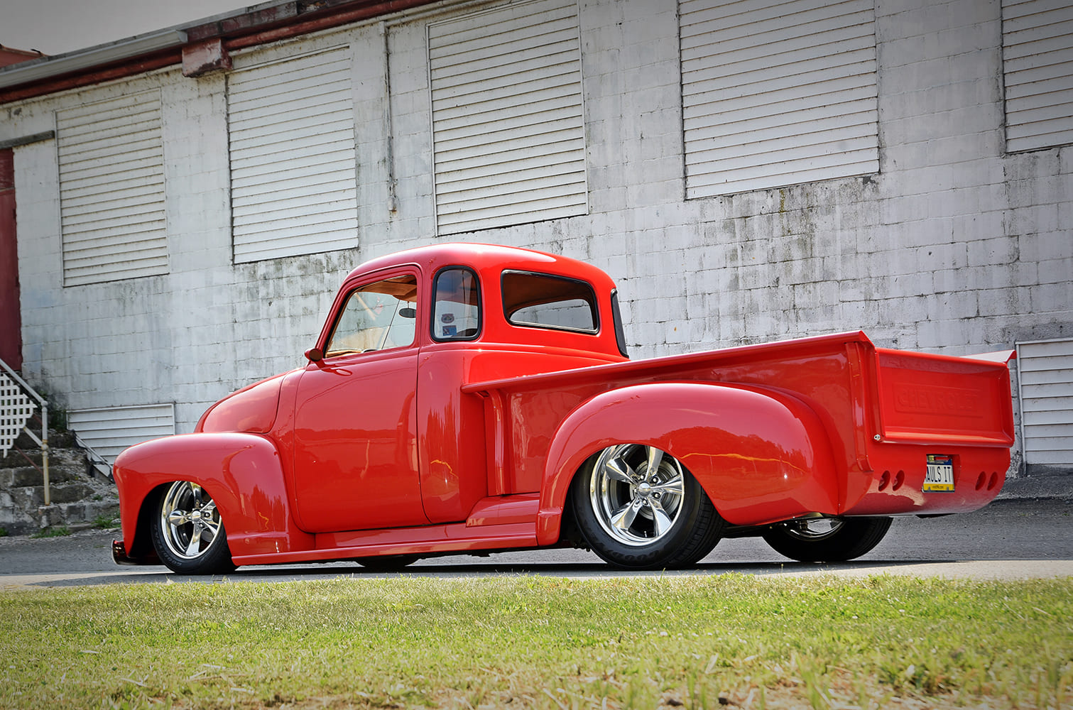 1947 Chevrolet 3100 custom red pickup truck rear three quarter view smooth bed shaved tailgate