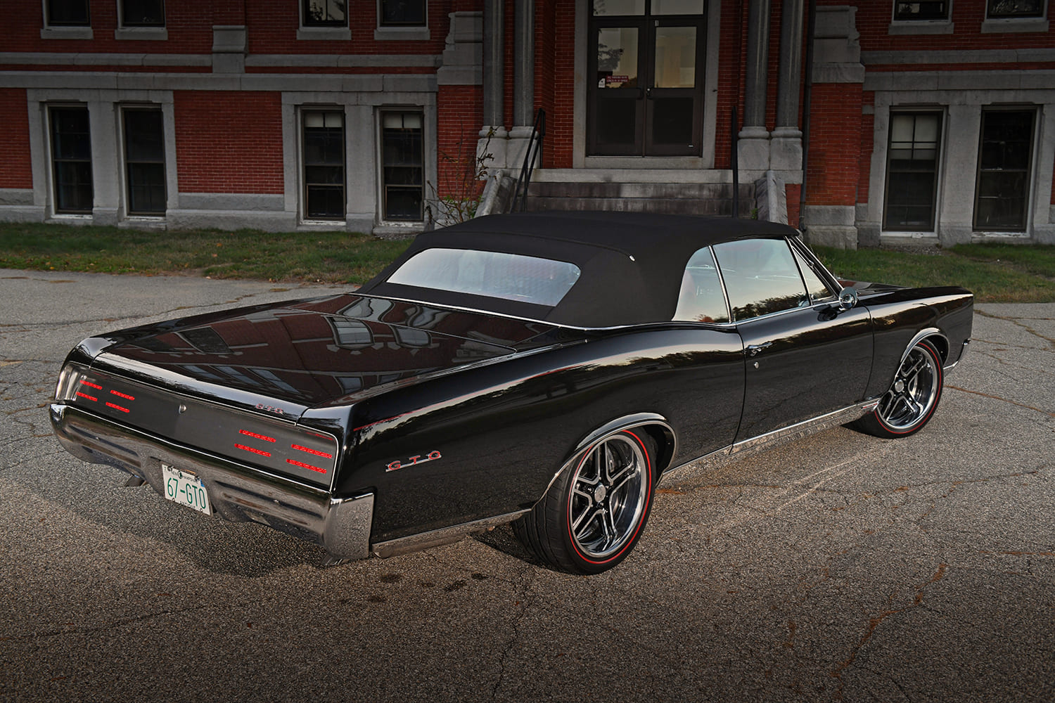 67 Pontiac GTO black convertible restomod rear three quarter view LED taillights custom wheels