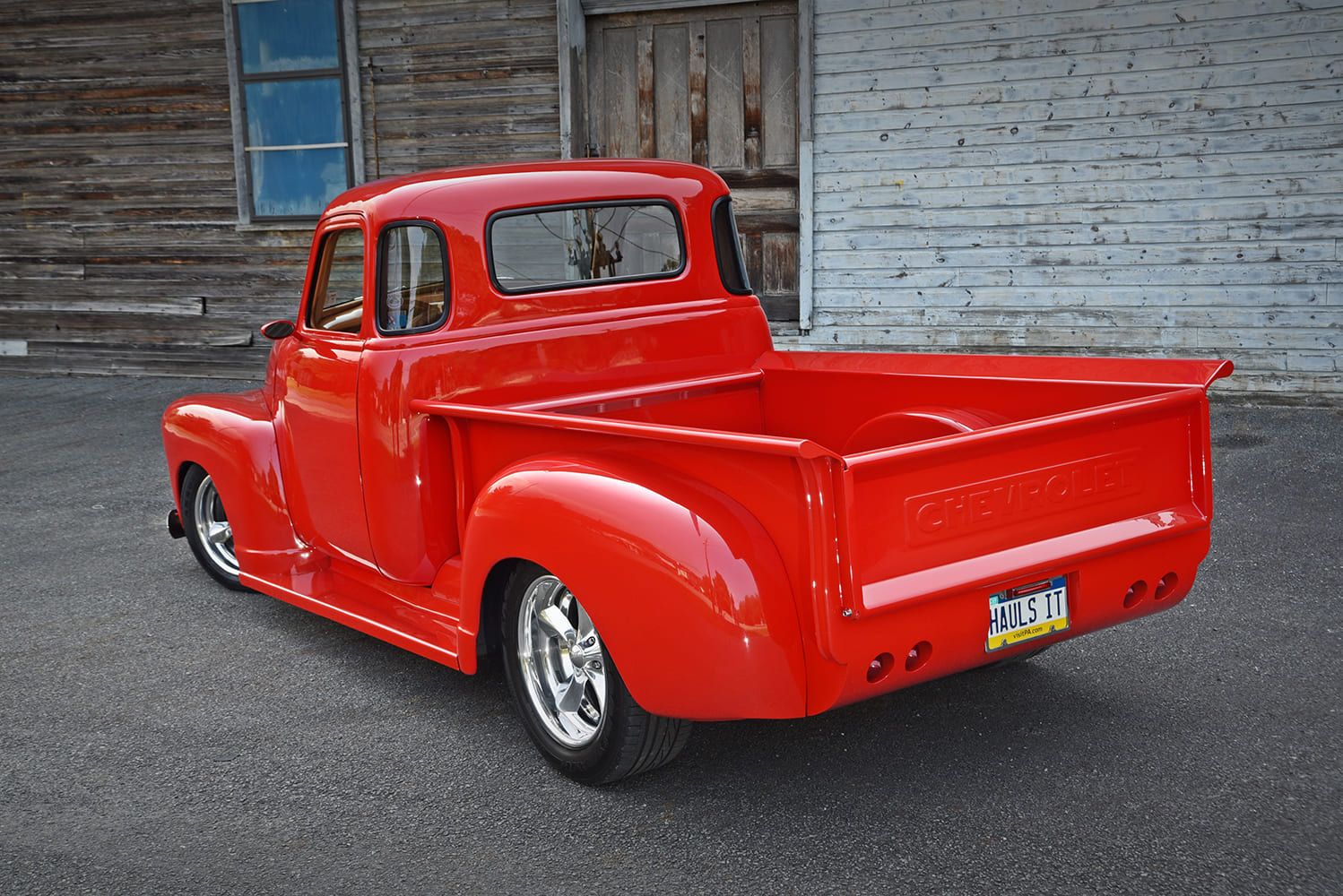Chevrolet 3100 custom red pickup truck rear angle embossed Chevrolet tailgate lowered classic truck