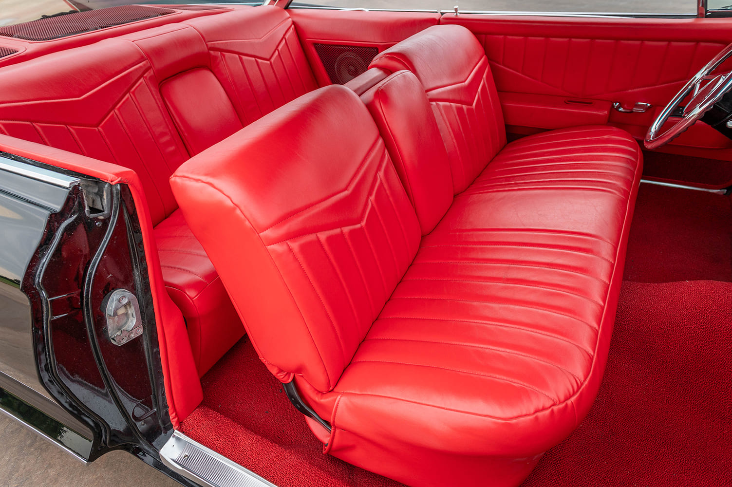 1961 coupe deville red interior front bench seat classic cabin upholstery detail