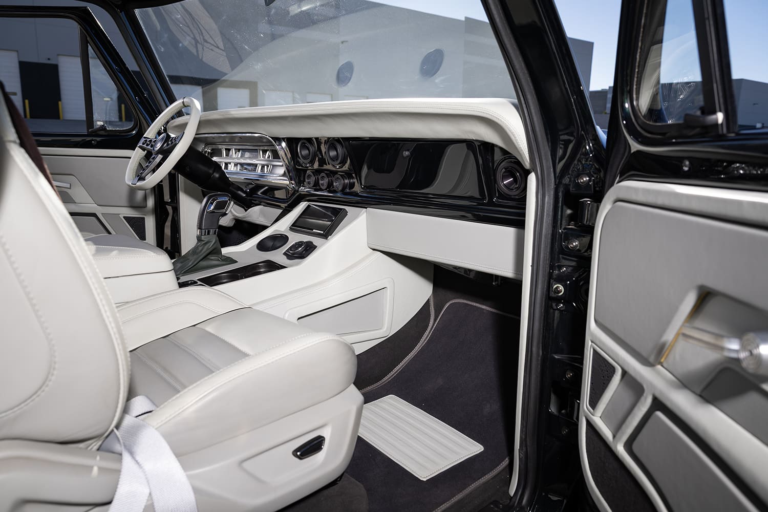 F100 custom cabin passenger view white leather panels premium audio system