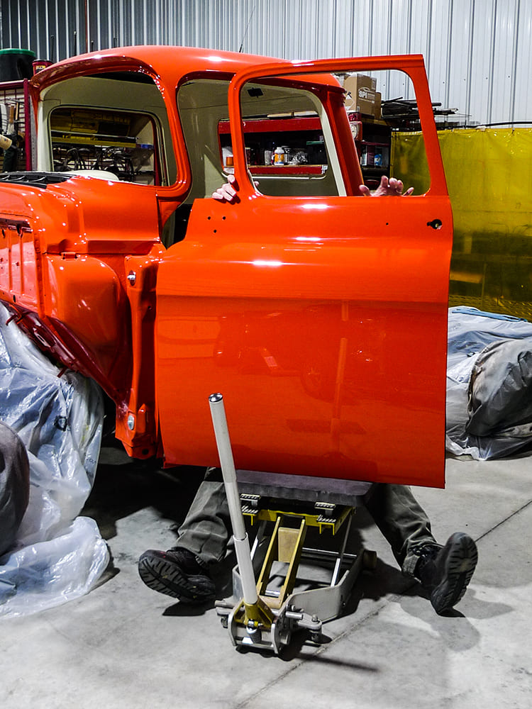 55 Chevy 3100 passenger door installation and fitment on freshly painted orange cab