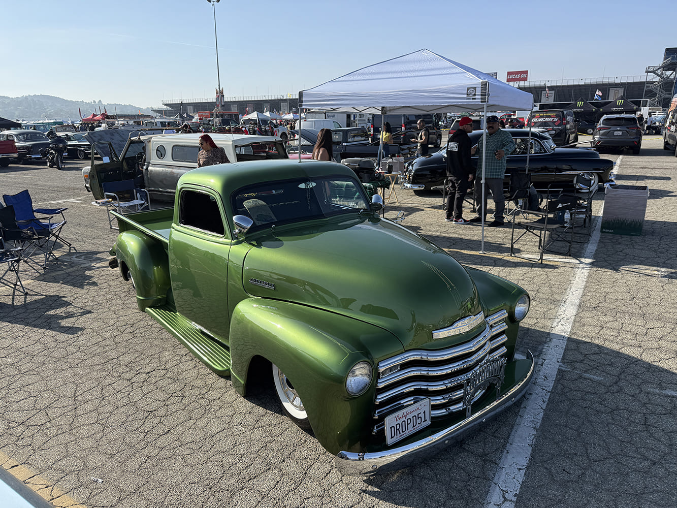 Chevrolet 3100 custom metallic green lowered pickup truck classic car show parking lot display