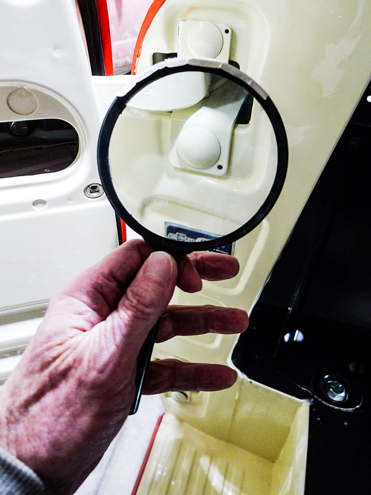 3100 door hinge cover inspection with magnifying glass restoration process