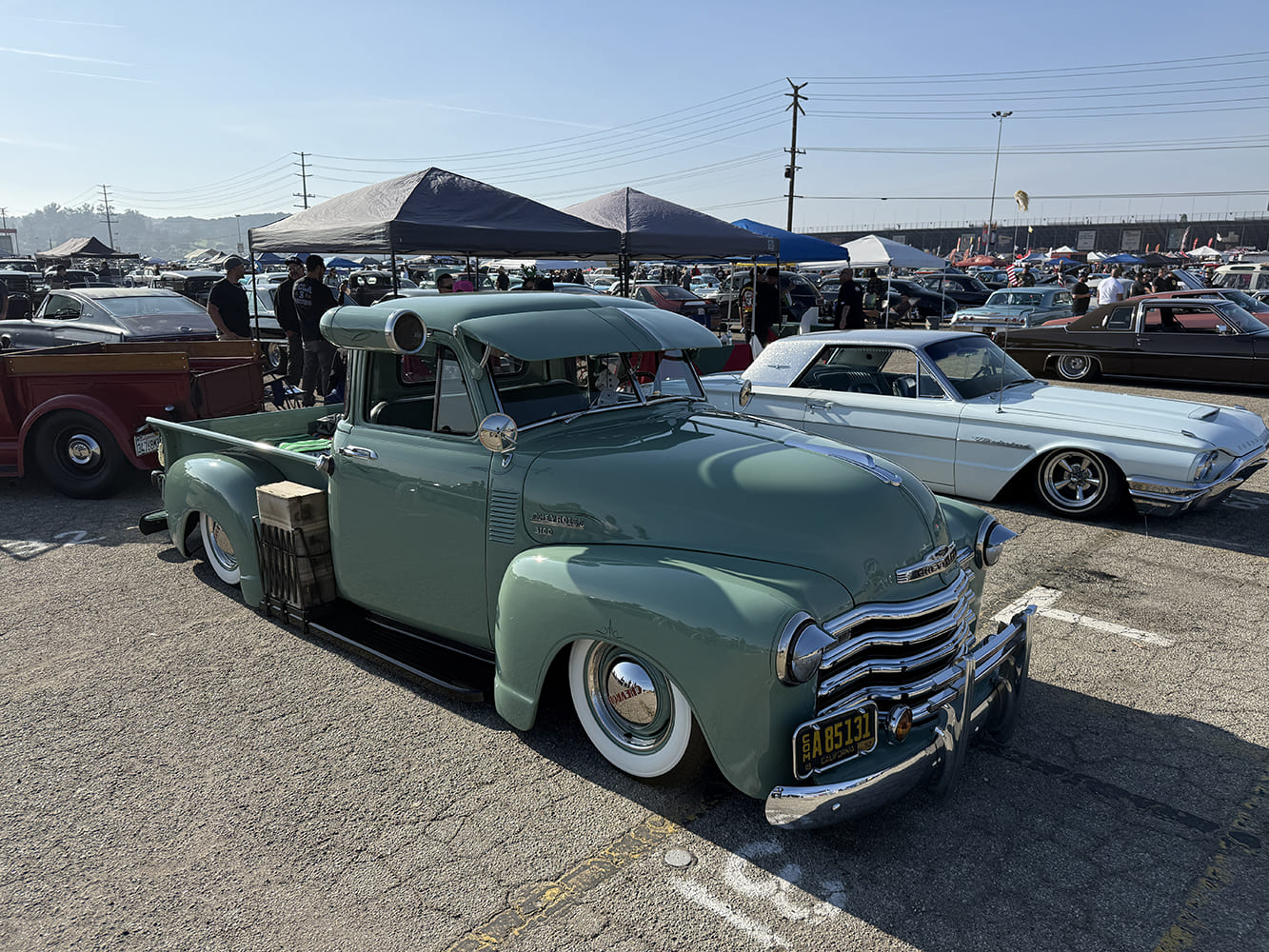 50 Chevrolet 3100 five window green lowered classic pickup truck whitewall tires car show