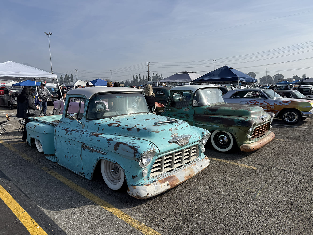 1955 Chevrolet 3100 turquoise patina lowered pickup and 1955 Chevrolet 3100 green patina classic truck pair car show