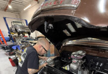 1949 Chevrolet 3100 pickup radiator install custom aluminum radiator mechanic working engine bay