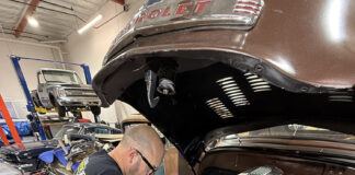 1949 Chevrolet 3100 pickup radiator install custom aluminum radiator mechanic working engine bay