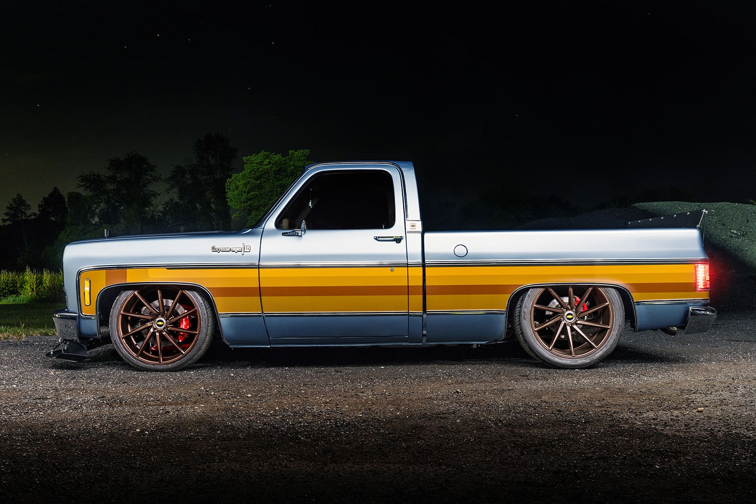 1982 Chevrolet C10 side profile lowered truck orange stripe large wheels custom suspension night shot
