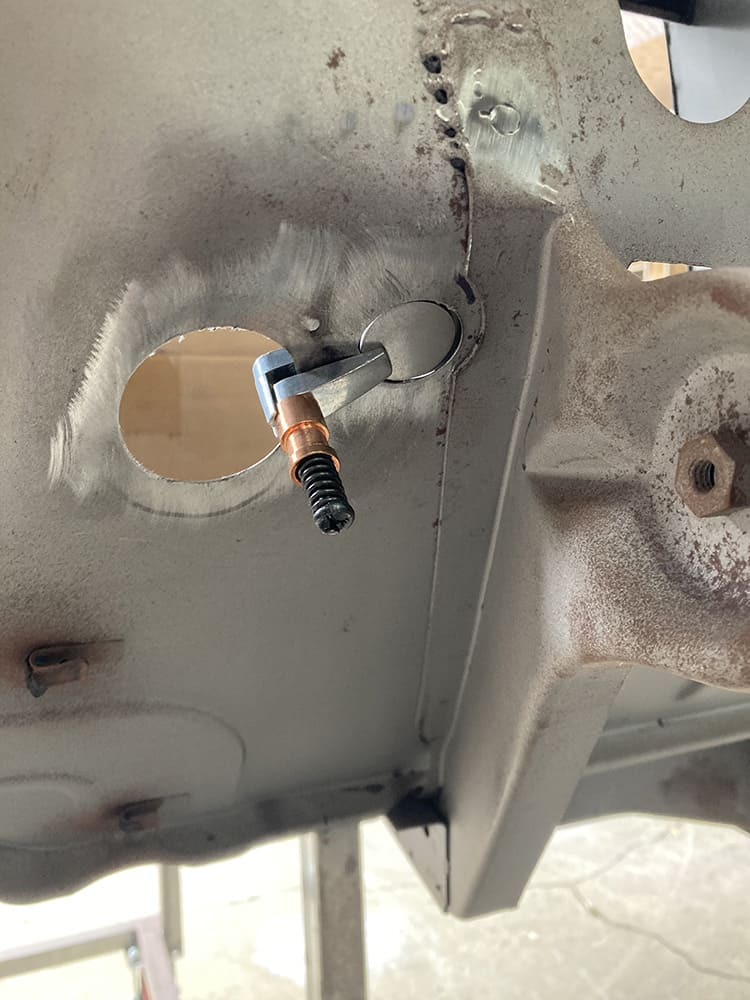 firewall hole repair welding tool clamp technique close up