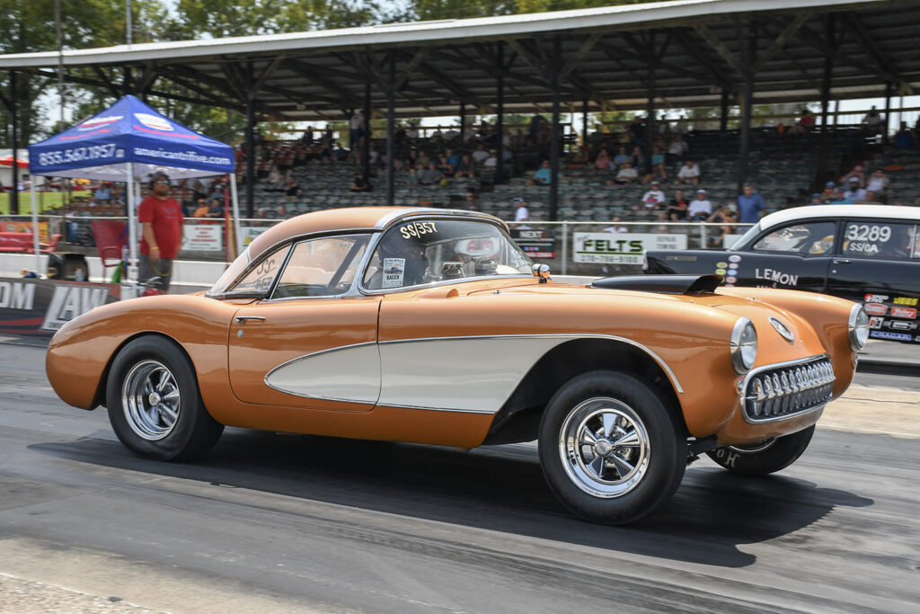 Bronze and white 1956–1957 classic Chevrolet Corvette gasser drag car accelerating down the track at Beech Bend Raceway.