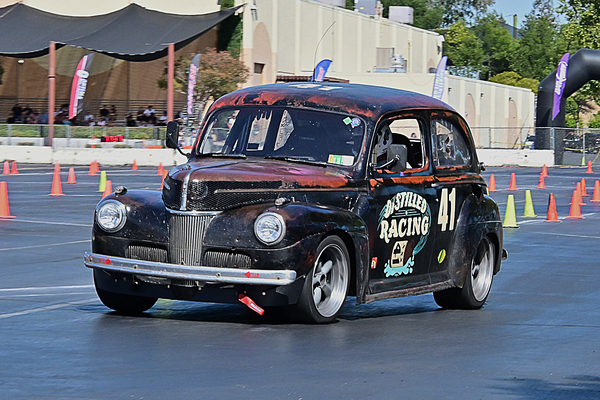 Front three-quarter view of the Distilled Racing #41 patina 1941 Ford sedan autocross racer navigating the cone course at the Goodguys Pleasanton West Coast Nationals.
