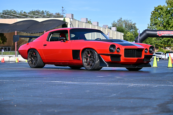 Front three-quarter view of Nick Relampagos’ bright red second-gen Chevrolet Camaro RS autocross machine on the track at the Goodguys Pleasanton West Coast Nationals.