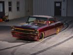 Pro Touring Style 1967 Nova Restomod Custom 1967 Chevrolet Chevy II Nova restomod in deep candy apple red paint with gold accents and custom wheels parked outside a workshop.