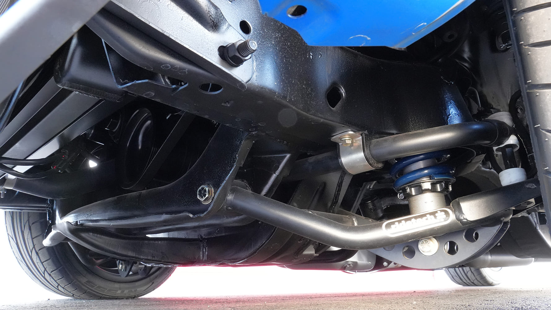 Undercarriage shot showing the heavy-duty Ridetech front sway bar, tubular lower control arms, and coilover suspension assembly.